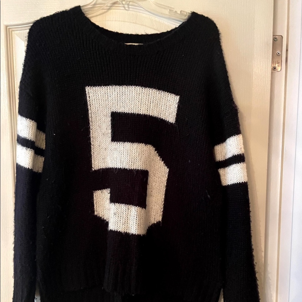Black and white sweater with the number 5